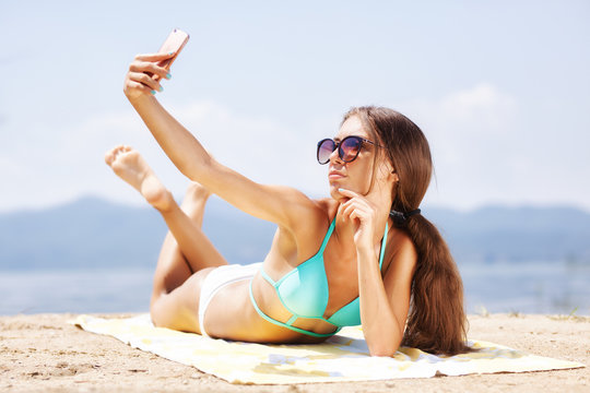 girl taking selfie on a beach