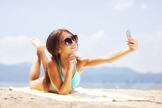 girl taking selfie on a beach