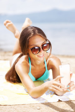 girl taking selfie on a beach