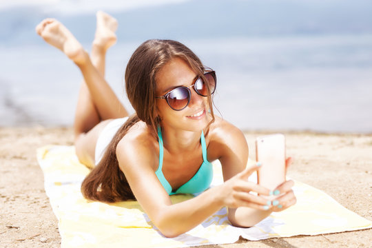 girl taking selfie on a beach