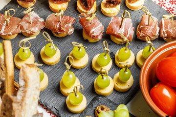 table with different type of snacks preparing for party.