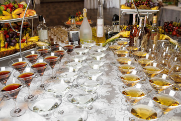 Different glasses with alcohol whiskey and wine on the table at 