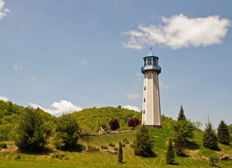 Fototapeta na wymiar A lighthouse under beautiful blue skies in Tionesta, Pennsylvania