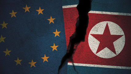European Union vs North Korea  Flags on Cracked Wall
