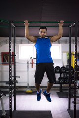 Fototapeta premium man doing pull ups on the horizontal bar