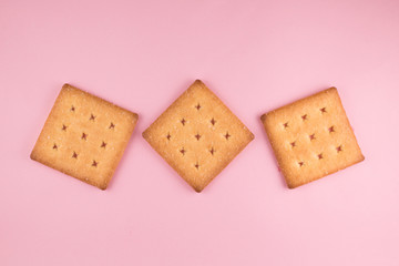 top view of three sugar cracker isolated on pink background. food and snack concept