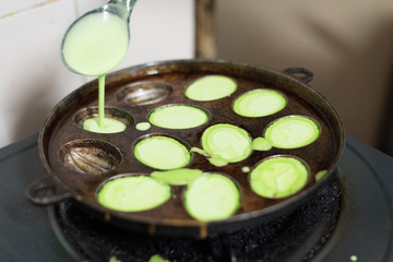 preparing or cooking KUIH CARA MANIS, a malay traditional cuisine in malaysia. made from mixing flour,water and pandan leaf