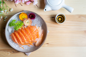 Salmon sashimi slice fresh serve on ice with tea, Japanese style - Powered by Adobe