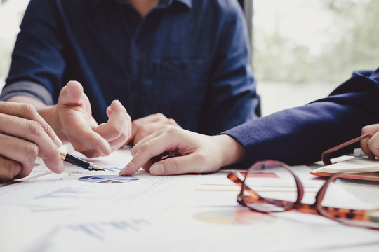 Asian business adviser meeting to analyze and discuss the situation on the financial report in the meeting room.Investment Consultant,Financial Consultant,Financial advisor and accounting concept