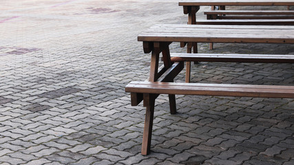 Wooden chairs and tables in the park.