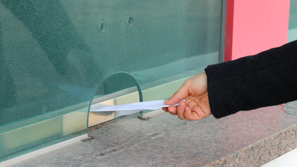 The girl's hand at the ticket office.