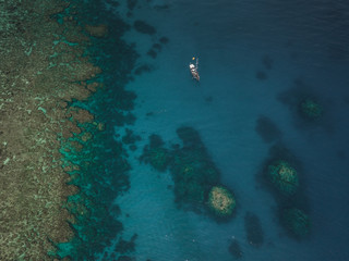 Sailboat Anchored Next to Coral Reef