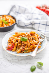 Italian food and pasta pene with bolognese sause on plate