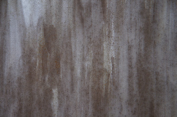 gray-brown paint on metal with rust