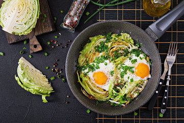 Fried eggs with slices of young cabbage and greens. Nutritious breakfast. Top view. Flat lay