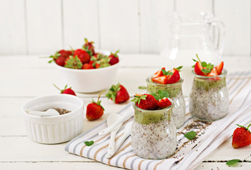 Detox and healthy superfoods breakfast in jar. Vegan coconut milk chia seeds pudding with strawberries and kiwi.