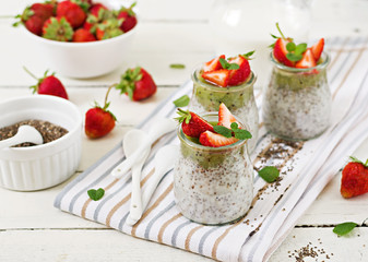 Detox and healthy superfoods breakfast in jar. Vegan coconut milk chia seeds pudding with strawberries and kiwi.