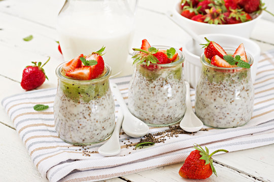 Detox and healthy superfoods breakfast in jar. Vegan coconut milk chia seeds pudding with strawberries and kiwi.