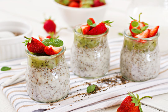 Detox and healthy superfoods breakfast in jar. Vegan coconut milk chia seeds pudding with strawberries and kiwi.