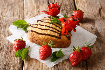 Delicate cake with chocolate, mint and strawberry rose close-up. horizontal, Valentine's Day