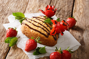 sponge cake decorated with chocolate, mint and strawberry rose close-up. horizontal