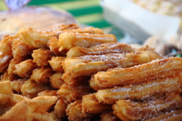 alfajores fried cakes and churros for sale at the street fair