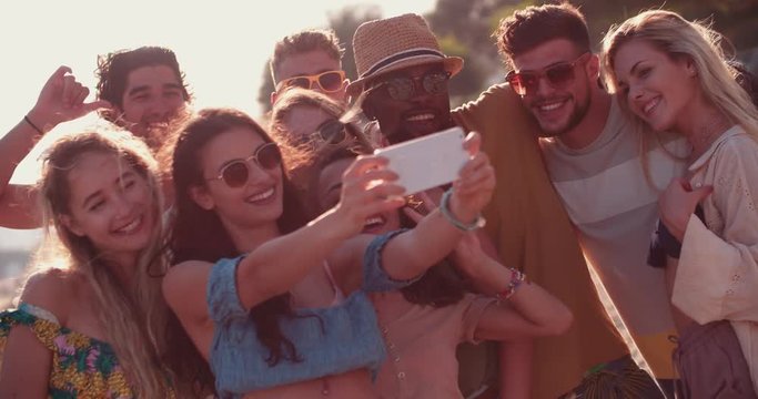 Young multi-ethnic hipster friends taking selfies on island summer holidays
