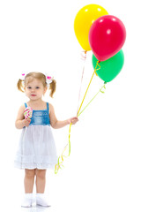 Little girl is playing with a balloon