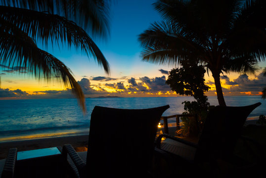 Empty Chair At A Deserted Quiet Peaceful Sandy Beach During Sunset At Horizon On The Water In Fiji For Honeymoon Vacation