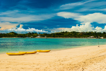 Playing with banana boat at an empty quiet calm peaceful island under sunny blue cloudy sky in the honeymoon vacation