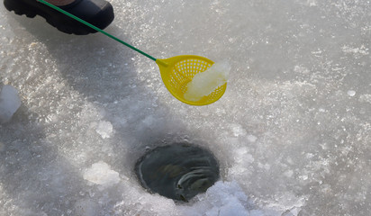 Ice fishing at lake.