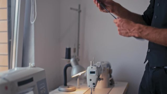 Bearded Tailor Designer is Making a Pattern on the Fabric before Sew Fashionable Clothes