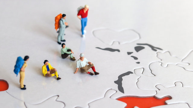 Miniature tourists on world map