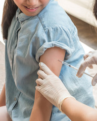 Immunization and vaccination for polio, flu shot, influenza or HPV prevention with young child girl...