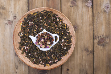 Different tea with flowers and herbs on a wooden background. Aromatherapy and health. Copy space