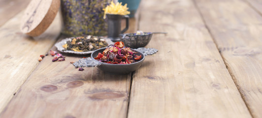 Assorted dried flowers and tea on a wooden background. Natural health. Aromatherapy. Free space for text. Copy space. Long format. Banner