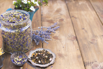 Obraz na płótnie Canvas Assorted dried flowers and tea on a wooden background. Natural health. Aromatherapy. Free space for text. Copy space