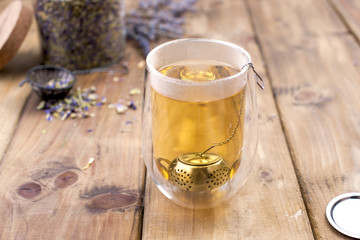 A mix of herbal tea with lavender, on a wooden background. Vintage photo. Free space for the text. Copy space.