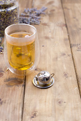 A mix of herbal tea with lavender, on a wooden background. Vintage photo. Free space for the text. Copy space.