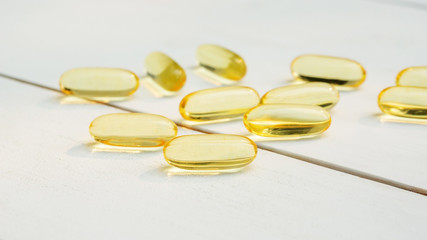 Fish oil on a white wooden table.