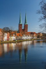 Fototapeta na wymiar Twin bell-towers of the medieval Gothic church in Lubeck, Germany