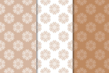 Brown floral backgrounds. Set of seamless patterns