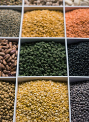 Indian Beans,Pulses,Lentils,Rice and Wheat grain in a white wooden box with cells, selective focus.