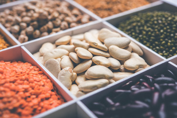 Indian Beans,Pulses,Lentils,Rice and Wheat grain in a white wooden box with cells, selective focus.
