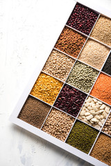 Indian Beans,Pulses,Lentils,Rice and Wheat grain in a white wooden box with cells, selective focus.