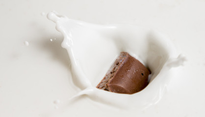 Chocolate falls in milk
