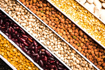 Indian Beans,Pulses,Lentils,Rice and Wheat grain in a white box with cells or strips, selective focus.