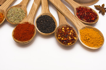 Spice. Spice in a wooden spoon. Herbs. Curry, saffron, turmeric, pepper and other isolated on white background.