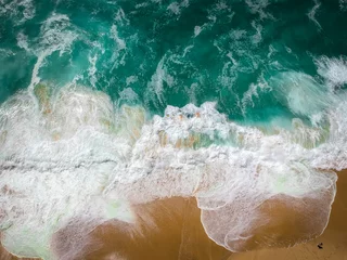 Fototapeten Sand beach aerial, top view of a beautiful sandy beach aerial shot with the blue waves rolling into the shore © nvphoto