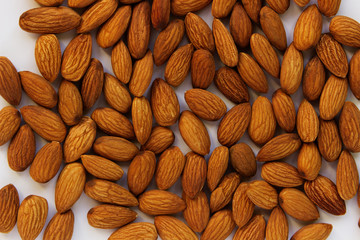 Almonds in bulk on a white background. Close-up, top view